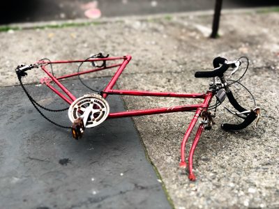 red and black road bike on ground